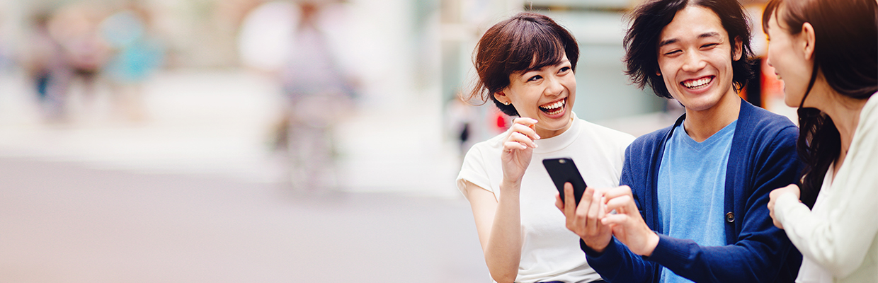 Three people chatting on the street happily; imaged used for HSBC Taiwan FX order page.